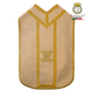 Emblematik by Pasamanerias y Bordados cream liturgical chasuble with gold lace trim and Marian monogram embroidery.