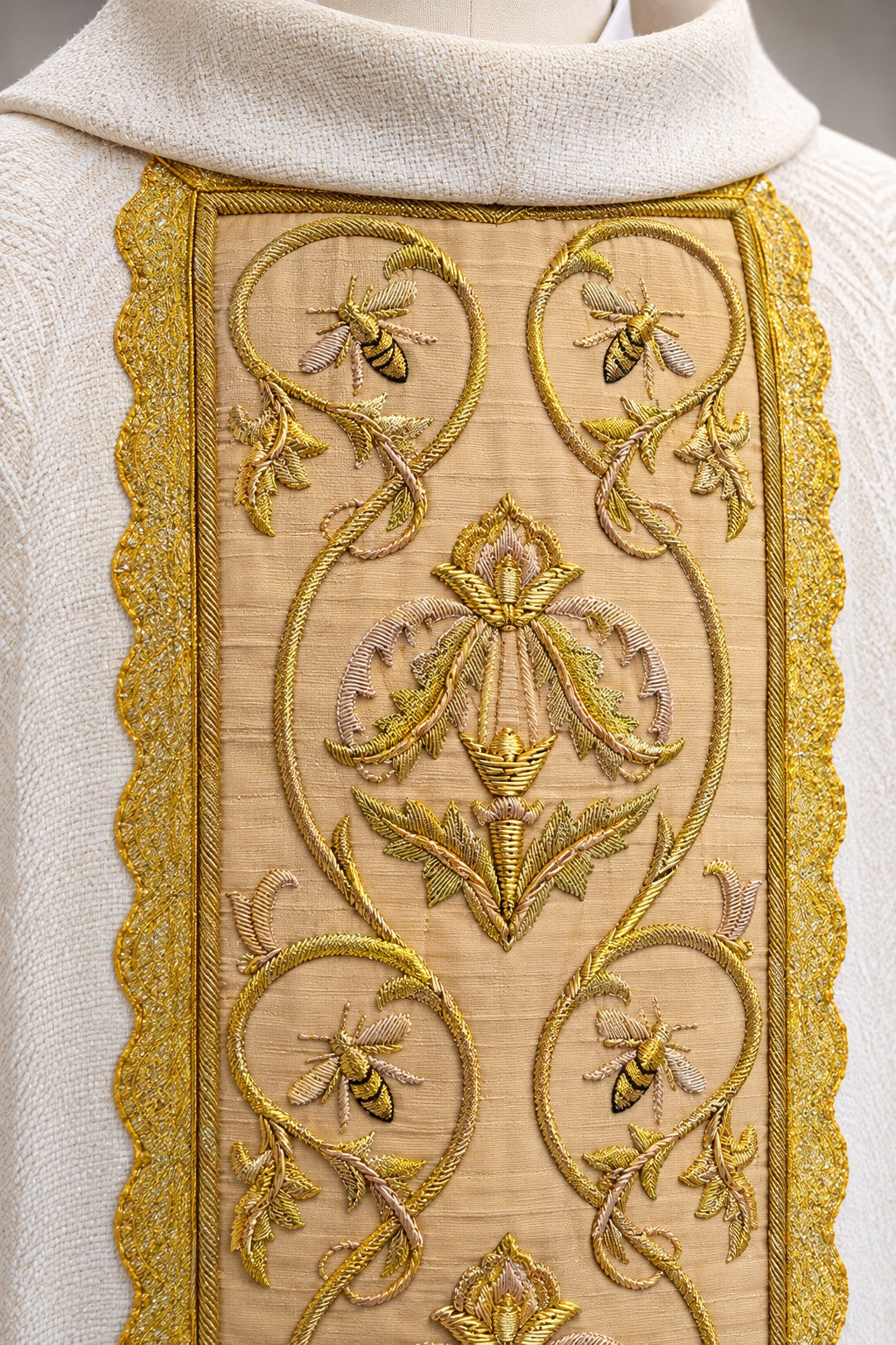 Close-up of handmade gold bullion embroidery and bee motifs